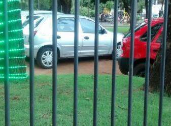 Carros estacionados dentro da praça. (Foto: Direto das Ruas)